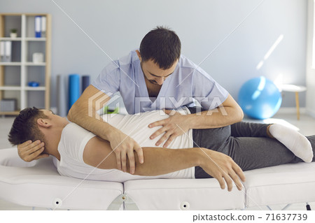 Chiropractor, osteopath, physiotherapist or manual therapist working with male patient Chiropractor, osteopath, physiotherapist or manual therapist working with male patient 71637739