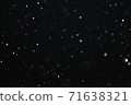 Snow illuminated by a flash flies in the dark 71638321
