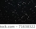 Snow illuminated by a flash flies in the dark 71638322