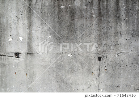 Old concrete wall with nail marks 71642410