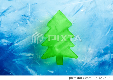 Christmas tree green ice shape on blue frozen background, 3d render Christmas tree green ice shape on blue frozen background, 3d render 71642528