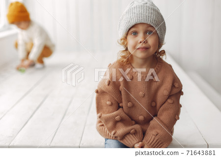 Cute little girl sitting in a studio Cute little girl sitting in a studio 71643881
