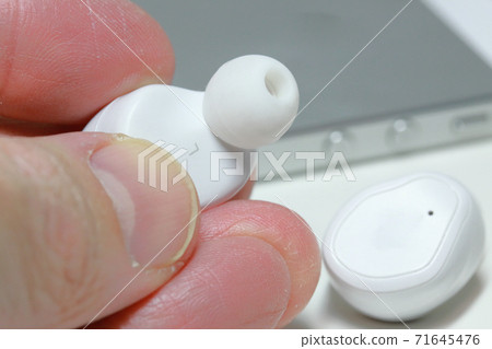 I have a wireless earphone in my hand 71645476