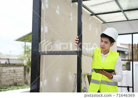 Architecture man checking building with tablet computer,Building inspector concept. 71646369