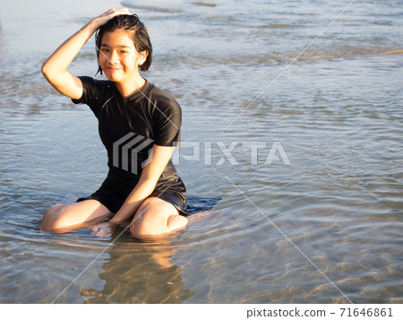 Teenage girl playing in the sea. 71646861