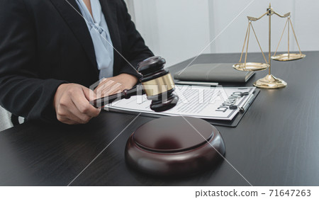 Judge or a lawyer works documents in the courtroom and analyze the various laws for justice and accuracy, Litigation and justice concept. Judge or a lawyer works documents in the courtroom and analyze the various laws for justice and accuracy, Litigation and justice concept. 71647263