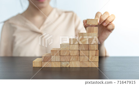 Arrange the wooden blocks into steps, higher the marketing strategy the more effort is required, Driving business at the peak concept. Arrange the wooden blocks into steps, higher the marketing strategy the more effort is required, Driving business at the peak concept. 71647915