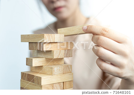 Arrange the wooden blocks into steps, higher the marketing strategy the more effort is required, Driving business at the peak concept. 71648101