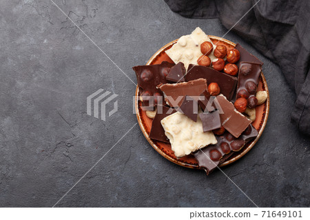Various chocolate pieces and nuts Various chocolate pieces and nuts 71649101
