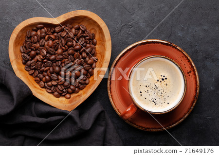 Roasted coffee beans in heart shaped bowl 71649176