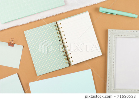 flat lay mint green stationery on work desk in brown pastel background 71650558