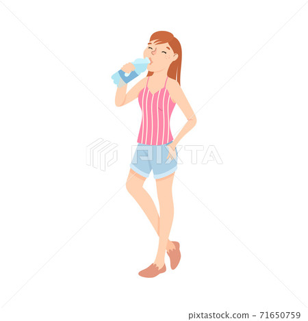 Teenage girl drinks water from bottle Stock Photo by