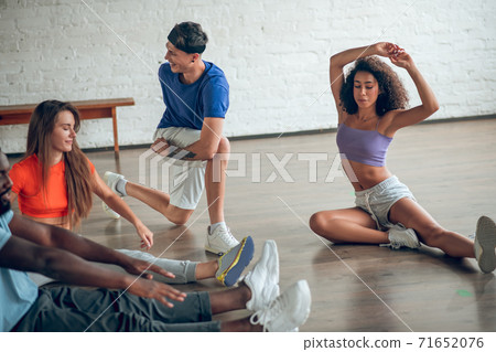 Group of dancers warming up before the rehearsal 71652076