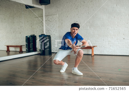 Man performing sit up while doing dance routine Man performing sit up while doing dance routine 71652565