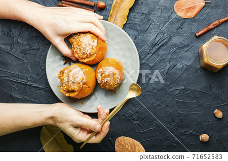 Baked persimmon with granola Baked persimmon with granola 71652583