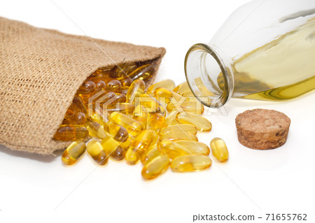 Omega 3 capsules in a bag and a bottle of fish oil 71655762