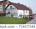 Facade thermal insulation and painting works, scaffolding in a village 71657348