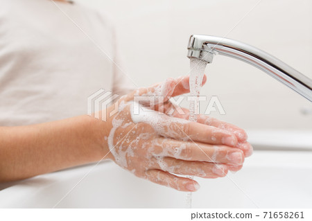 Washing hands in the bathroom. Washing hands in the bathroom. 71658261