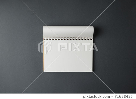 Open notepad on a gray background. Open notepad on a gray background. 71658455