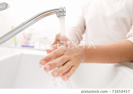 Washing hands in the bathroom. Washing hands in the bathroom. 71658457
