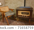 Antique radio and wooden chairs in a warm atmosphere 71658759