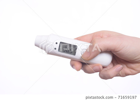 Electronic thermometer in a woman's hand Electronic thermometer in a woman's hand 71659197