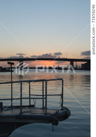Nagi harbor and ship tip with orange sunset and silhouette viaduct Nagi harbor and ship tip with orange sunset and silhouette viaduct 71659246
