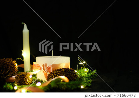 Pink Christmas decorations with candlels on a black background Pink Christmas decorations with candlels on a black background 71660478