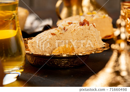 Piece of turkish halva on metal plate 71660498