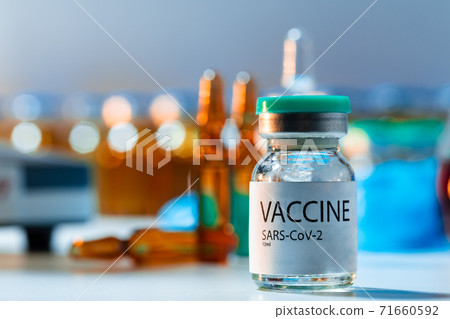 Vaccine vials of Sars-cov-2 on table in laboratory . Vaccine vials of Sars-cov-2 on table in laboratory . 71660592