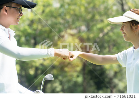 businessman and caddy giving fist bump to create stamina in training before playing golf in the lawn 71661021