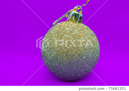 Gold and silver Christmas balloon toy on purple pattern background. Isolated Gold and silver Christmas balloon toy on purple pattern background. Isolated 71661351