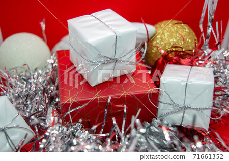 New year gift. Christmas background with gift boxes decorations on red. New year gift. Christmas background with gift boxes decorations on red. 71661352