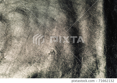 Black leather background with rich texture detail. close-up of black leather. A blurred background 71662132
