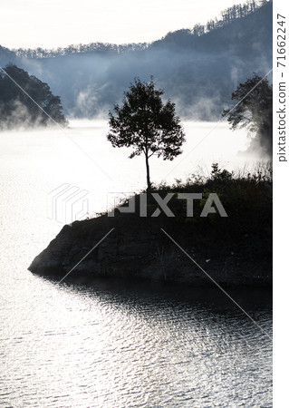 Morning by the river in the mist 71662247