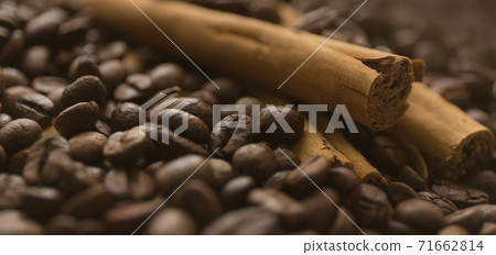 Cinnamon sticks on coffee beans blur background. Close up. 71662814