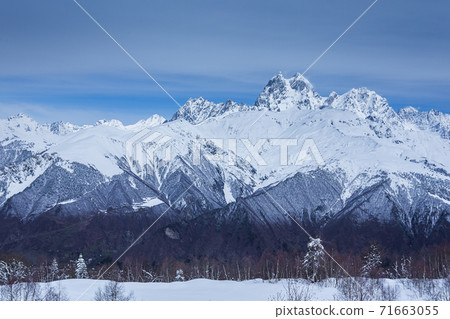 Panoramic view on high snowy mountains in winter at sunny day. Caucasus Mountains, Mount Ushba. Svaneti region of Georgia 71663055