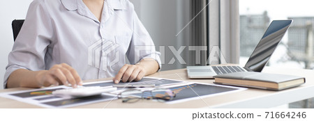 Chief marketing officer in Asia is analyzing the company's financial growth graph using personal computers for work, Working at home concept. Chief marketing officer in Asia is analyzing the company's financial growth graph using personal computers for work, Working at home concept. 71664246