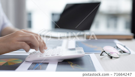 Chief marketing officer in Asia is analyzing the company's financial growth graph using personal computers for work, Working at home concept. Chief marketing officer in Asia is analyzing the company's financial growth graph using personal computers for work, Working at home concept. 71664247
