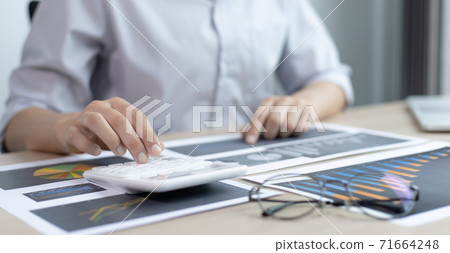 Chief marketing officer in Asia is analyzing the company's financial growth graph using personal computers for work, Working at home concept. Chief marketing officer in Asia is analyzing the company's financial growth graph using personal computers for work, Working at home concept. 71664248