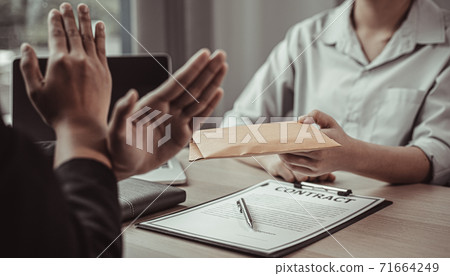 Businessmen give dollars to bribe employees in signing contracts to buy illegal land and real estate, Business fraud and social injustice, Anti Bribery and corruption concept. 71664249