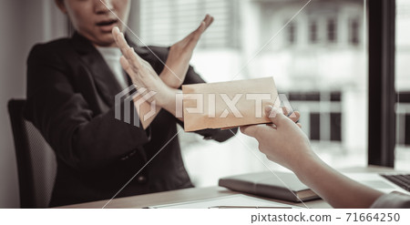 Businessmen give dollars to bribe employees in signing contracts to buy illegal land and real estate, Business fraud and social injustice, Anti Bribery and corruption concept. Businessmen give dollars to bribe employees in signing contracts to buy illegal land and real estate, Business fraud and social injustice, Anti Bribery and corruption concept. 71664250