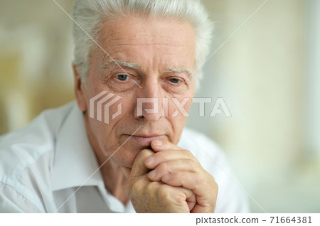 Close-up portrait of sad thinking senior man 71664381