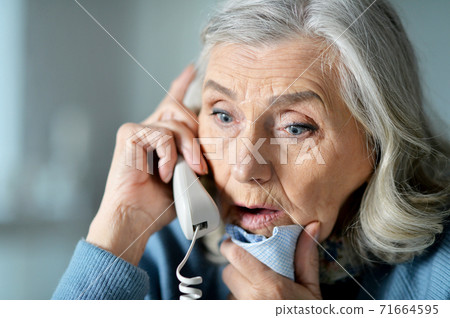 Portrait of upset senior woman calling doctor Portrait of upset senior woman calling doctor 71664595