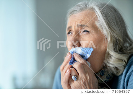 Portrait of a cute sad ill senior woman Portrait of a cute sad ill senior woman 71664597