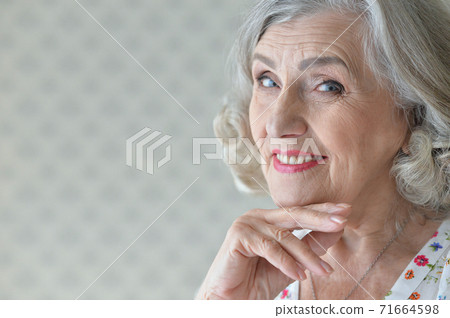 Portrait of beautiful happy senior woman at home Portrait of beautiful happy senior woman at home 71664598