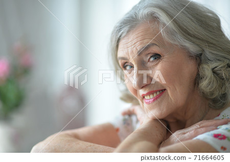Portrait of happy senior woman posing at home Portrait of happy senior woman posing at home 71664605