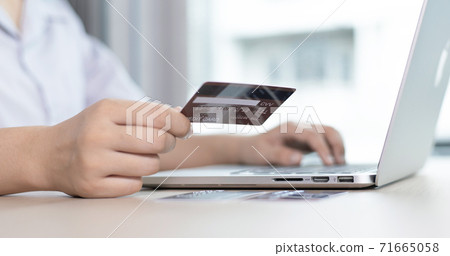 women use laptop to register online purchases using credit card payments, Convenience in the world of technology and the internet, Shopping online and banking online concept. 71665058