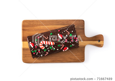 Chocolate yule log christmas cake isolated on white background Chocolate yule log christmas cake isolated on white background 71667489