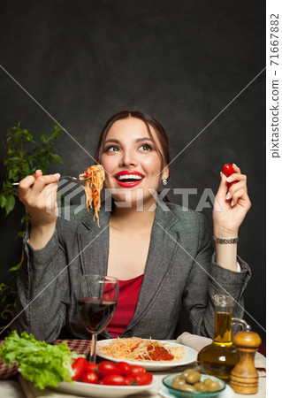 Attractive woman eating testy italian pasta in italian trattoria Attractive woman eating testy italian pasta in italian trattoria 71667882